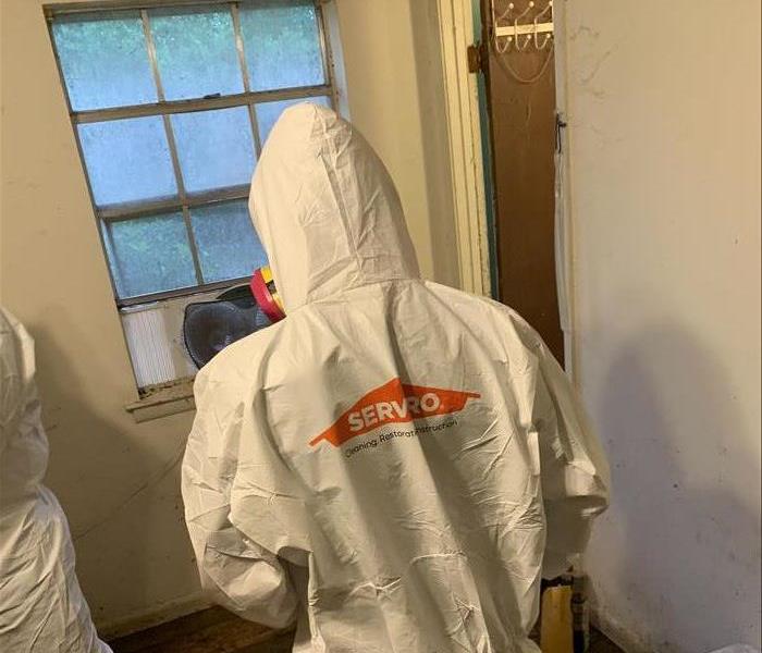 SERVPRO crew member in PPE during a biohazard cleaning job
